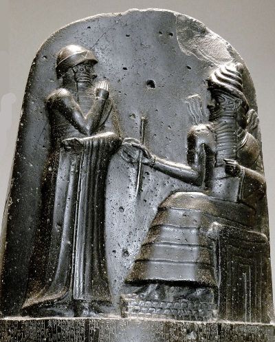 Hammurabi (standing) receiving his royal insignia from Shamash [image from Wikimedia Commons].