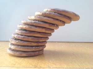 Ten chocolate gold grain biscuits, with a hangover of about one diameter.