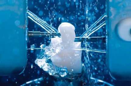 High-precision digitally-driven mill carving a dental crown from a solid ceramic block [photo from www.sirona.com].